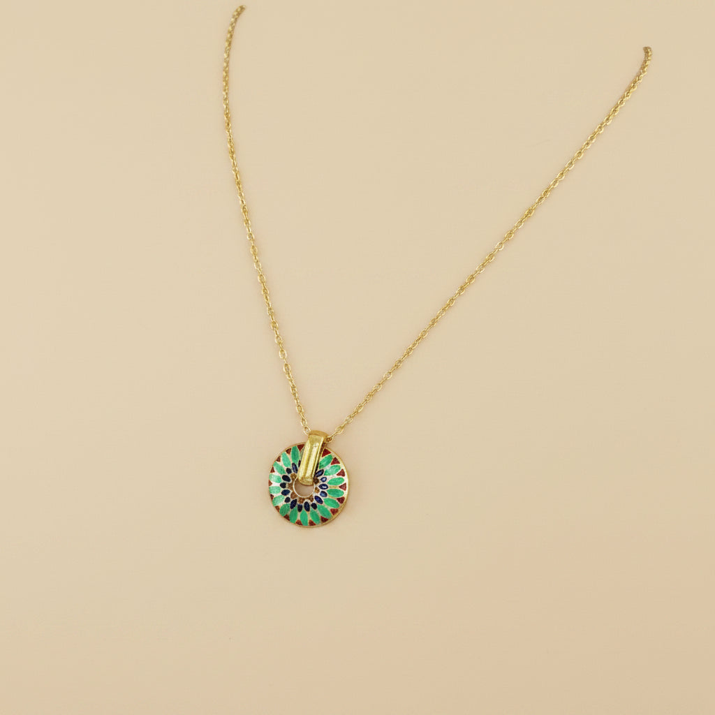 Set of gold necklaces with various pendants on a mannequin bust.