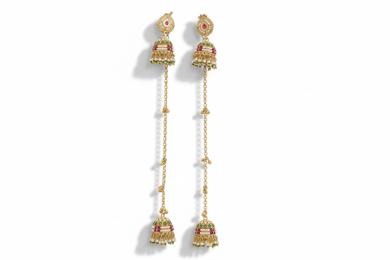 Pair of gold earrings with red gemstones on a white background