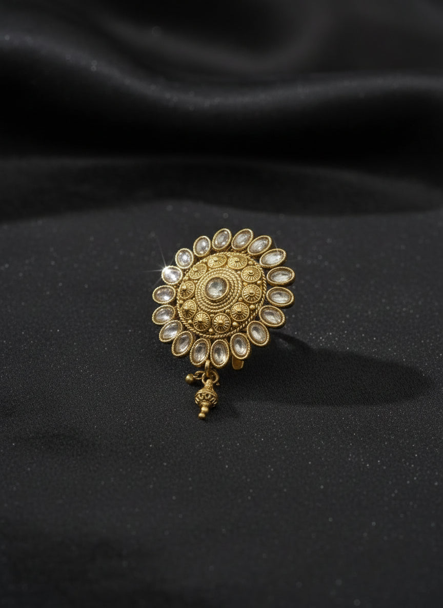 Gold decorative earring on a light gray background