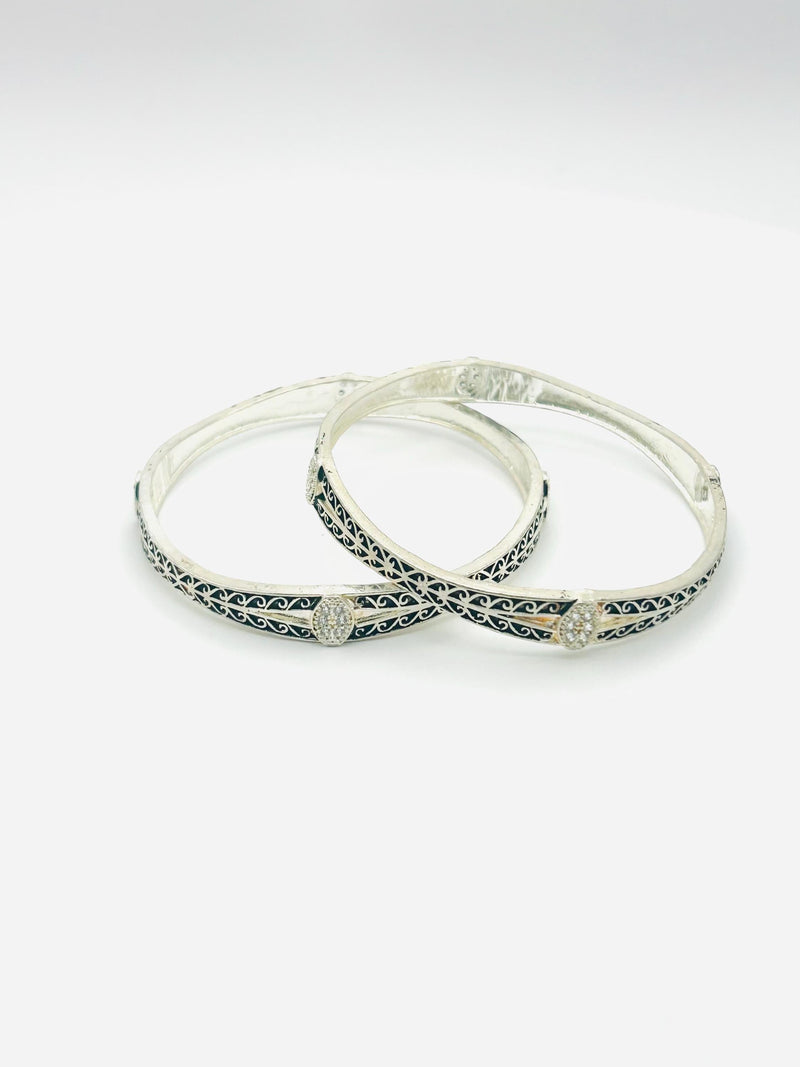 Pair of silver hoop earrings with black accents on a white background