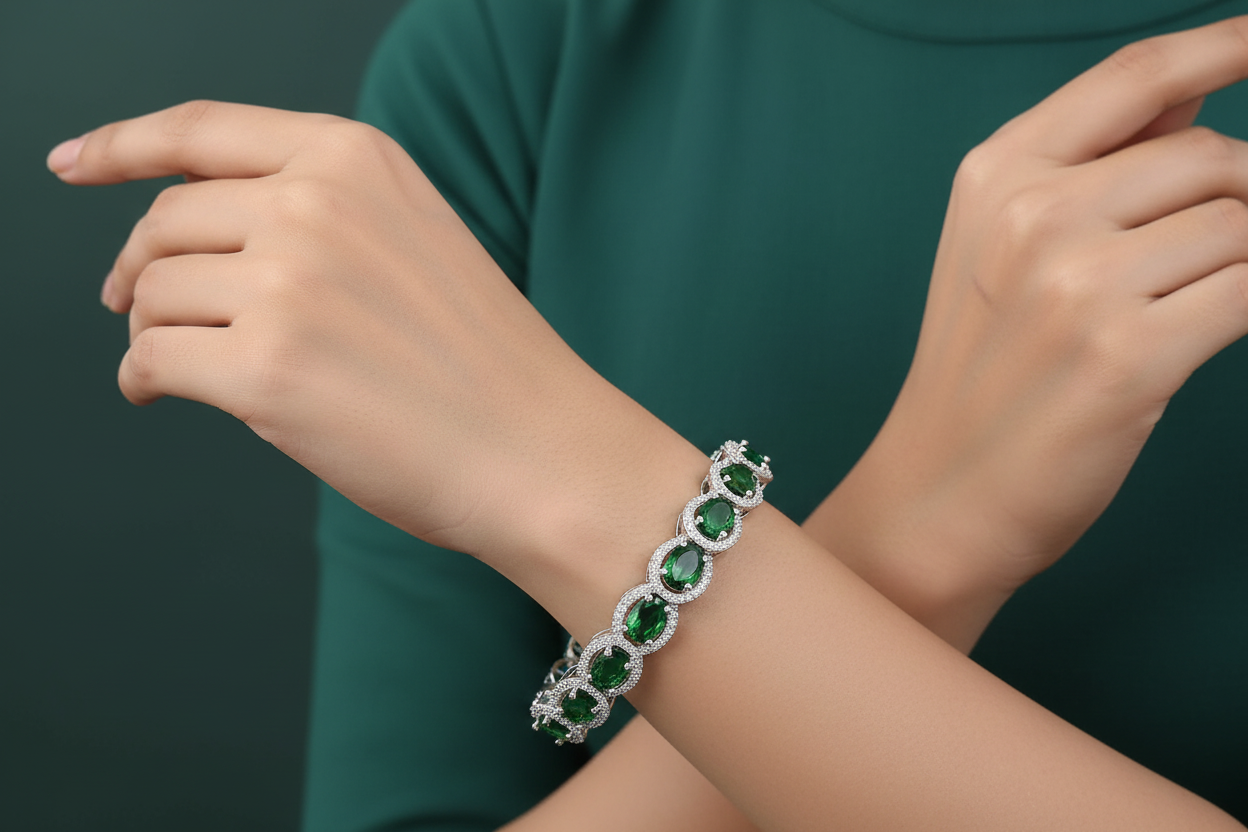 Bracelet with green gemstones on a person's wrist against a dark background