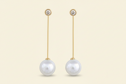 Pair of pearl drop earrings with anti tarnish gold plated on a white background