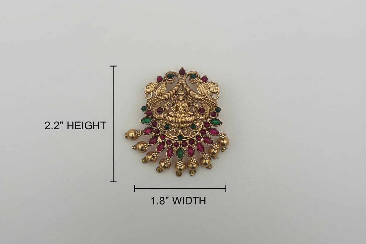 Decorative brooch with gold and gemstone details on a light gray background