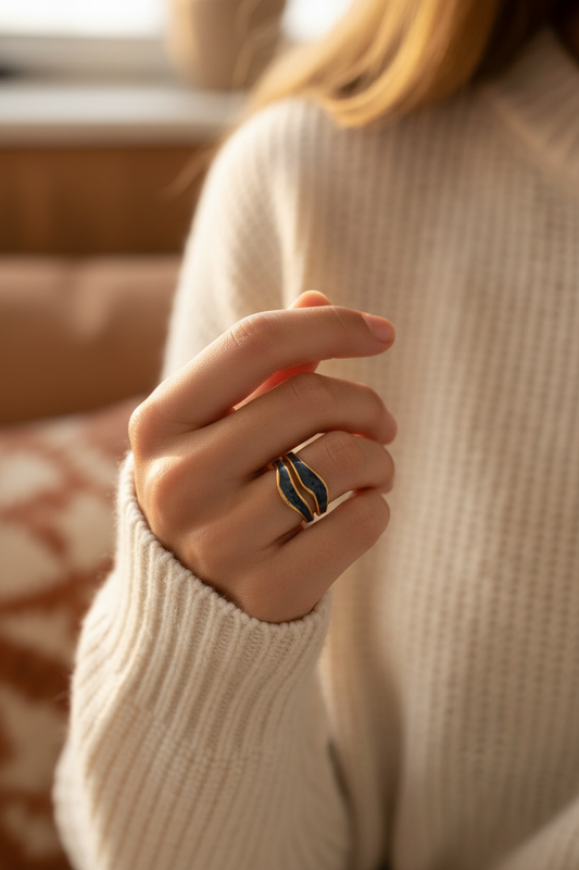 Close-up of a hand wearing a ring with a blurred background