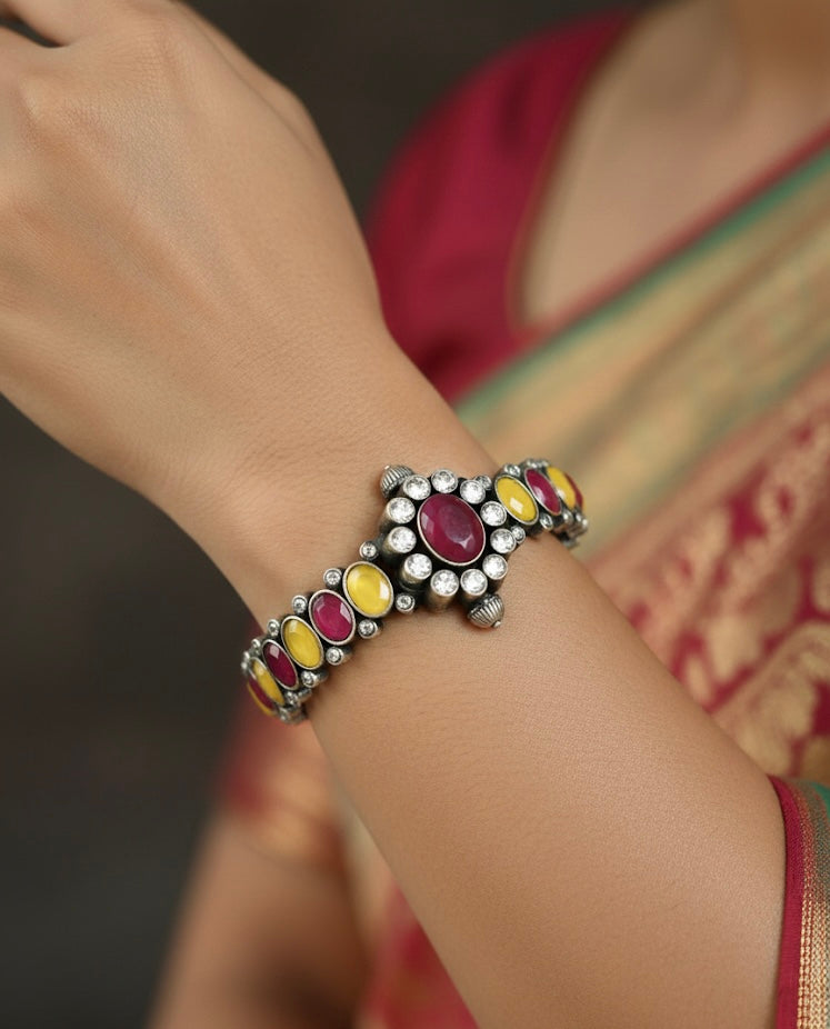 Bracelet with colorful stones on a wrist, blurred background