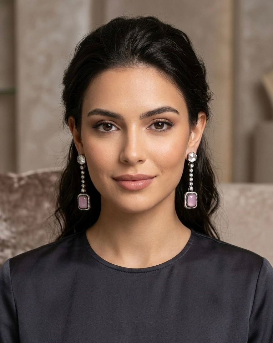 Woman wearing elegant earrings with a neutral background