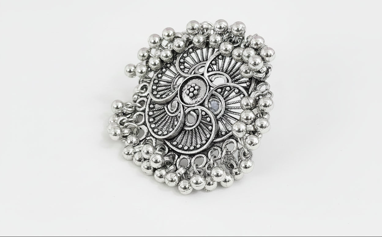oxidised Silver traditional ring with bead detailing on a green background
