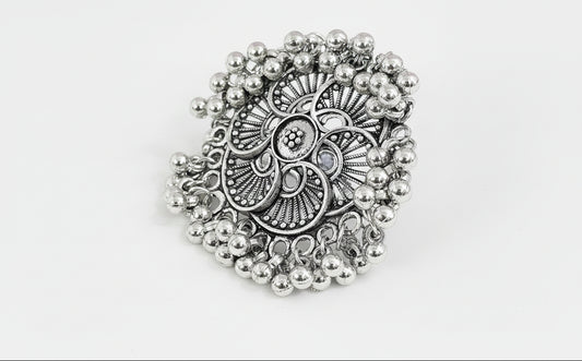 oxidised Silver traditional ring with bead detailing on a green background