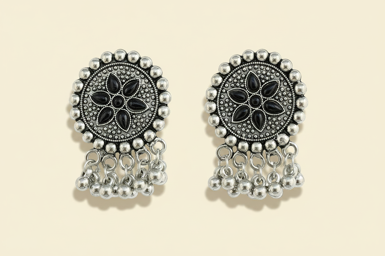 oxidize Pair of silver and black traditional floral earrings on a white background