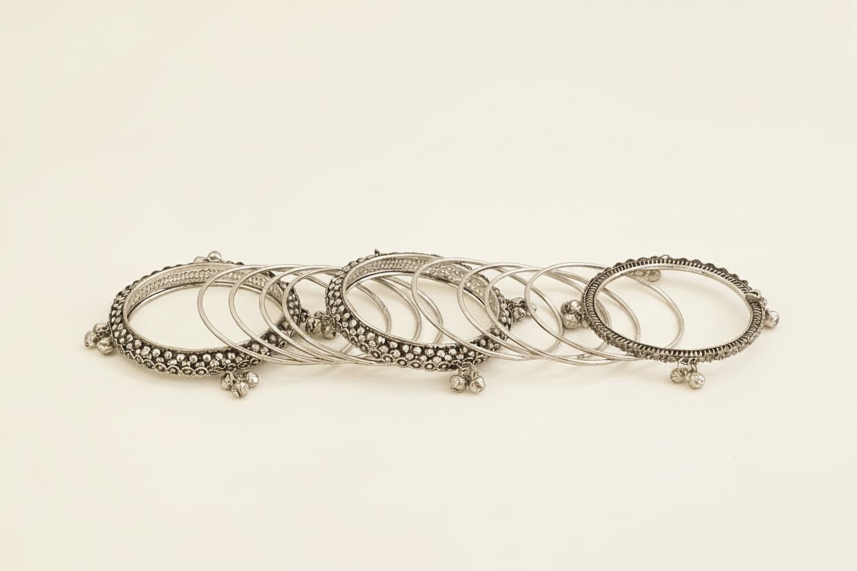 Set of oxidised silver traditional bangles on a white background