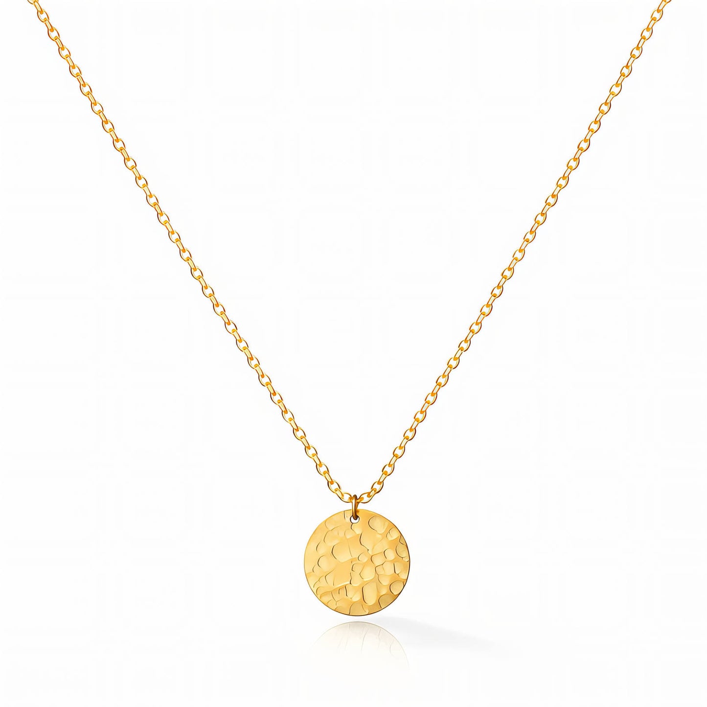 Gold necklace with a round pendant on a white background