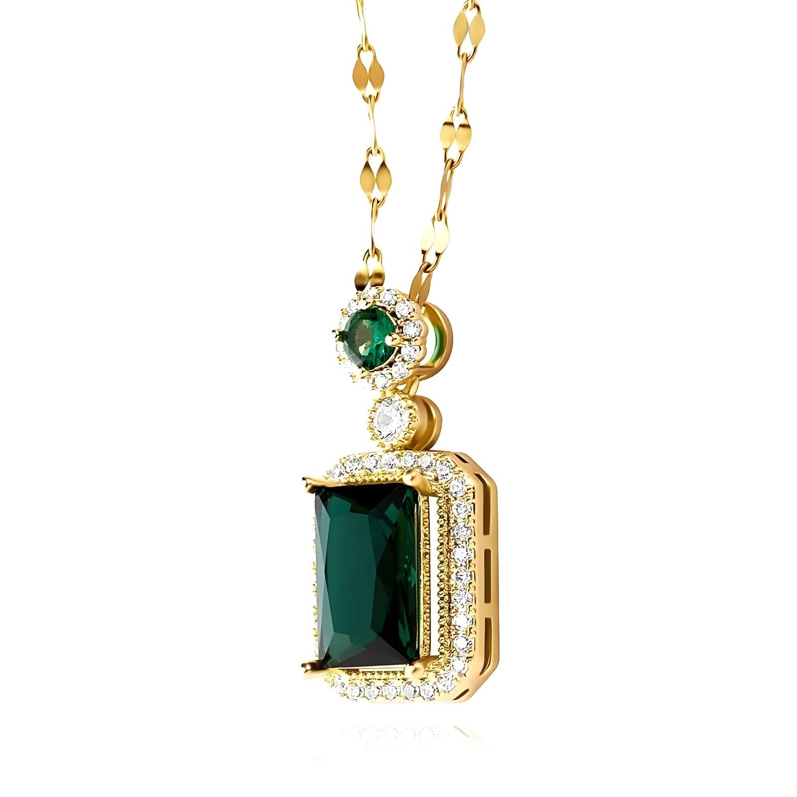 Gold necklace with green gemstone pendant on a white background