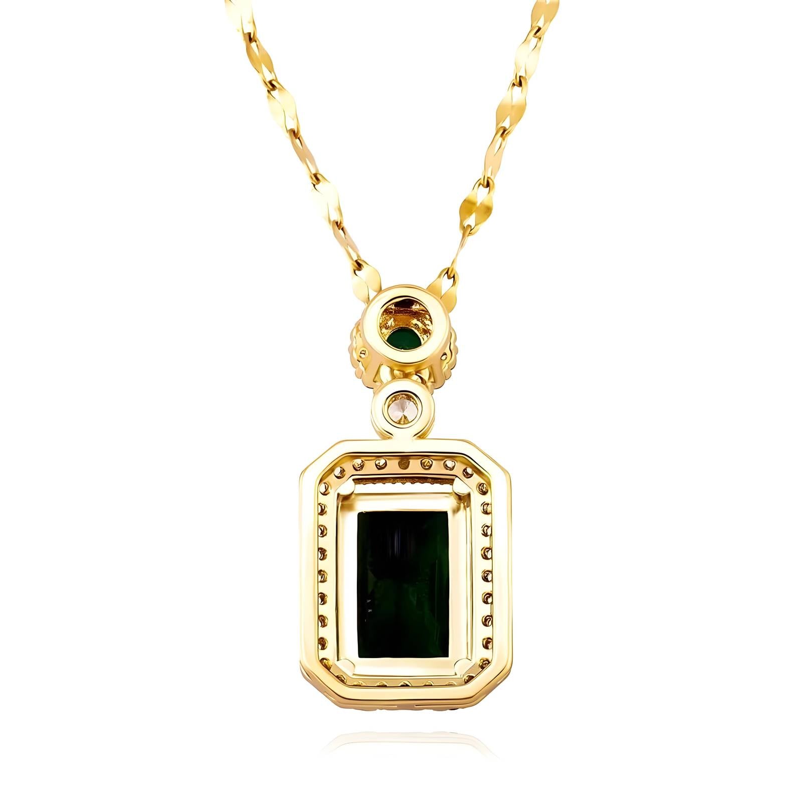 Gold necklace with a green gemstone pendant on a white background