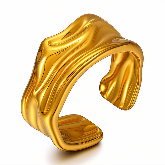 Gold ring with wavy design on a white background
