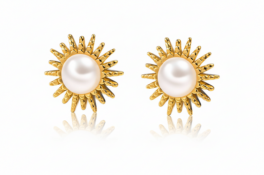 Gold plated sun-shaped earrings with pearl centers on a white background