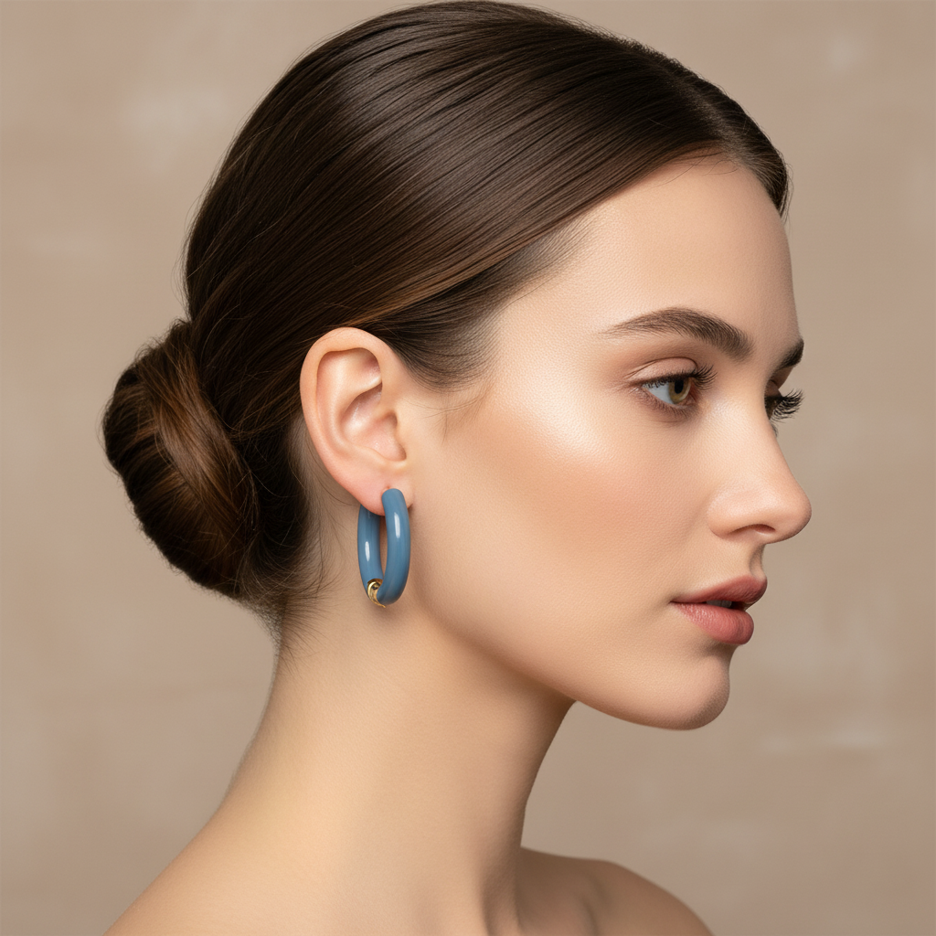 Woman wearing a blue earring against a beige background