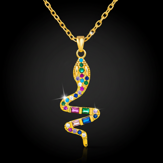 Gold snake-shaped pendant with colorful gemstones on a black background