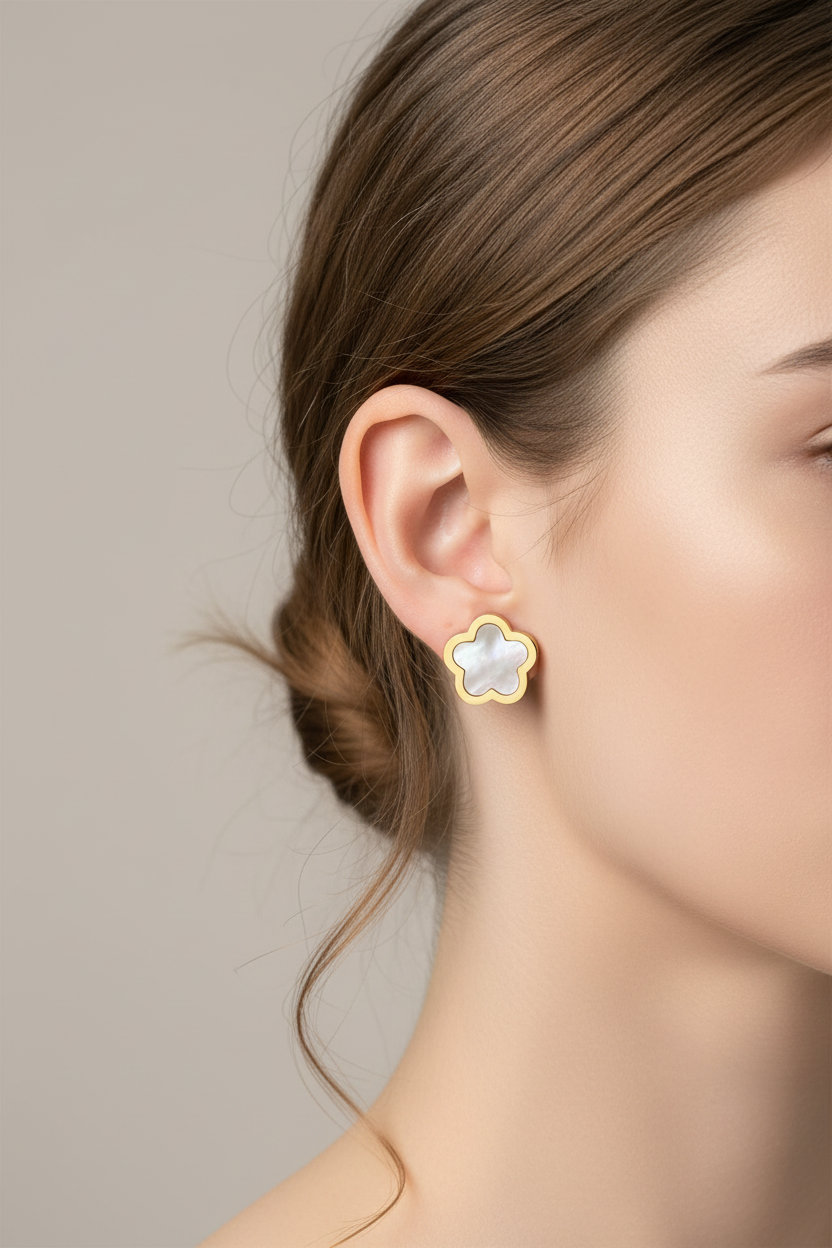 Close-up of a woman wearing a star-shaped earring with a neutral background