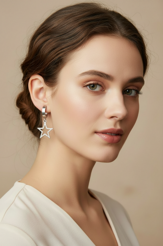 Woman wearing star-shaped earrings against a neutral background