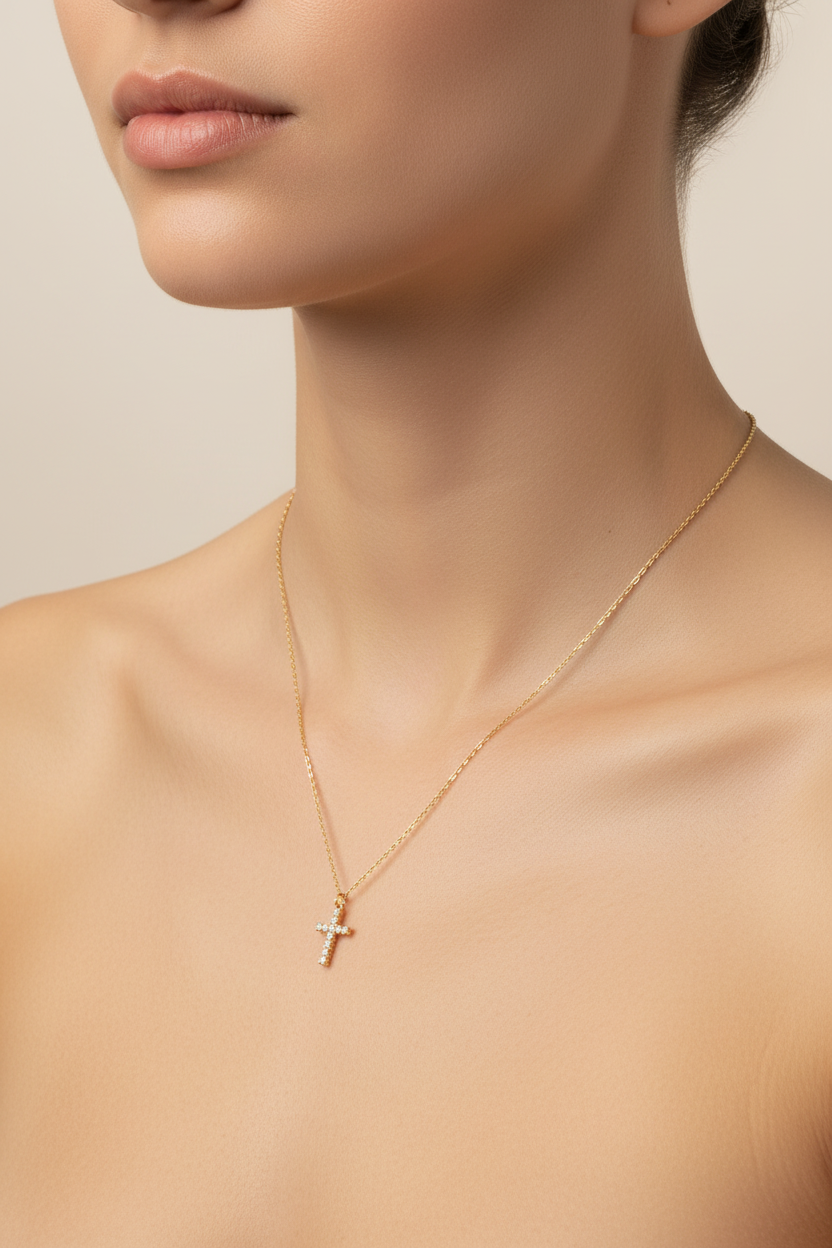 18k Gold plated necklace with a cross pendant on a person against a neutral background