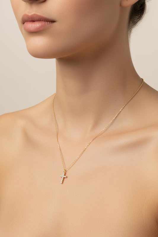 18k Gold plated necklace with a cross pendant on a person against a neutral background