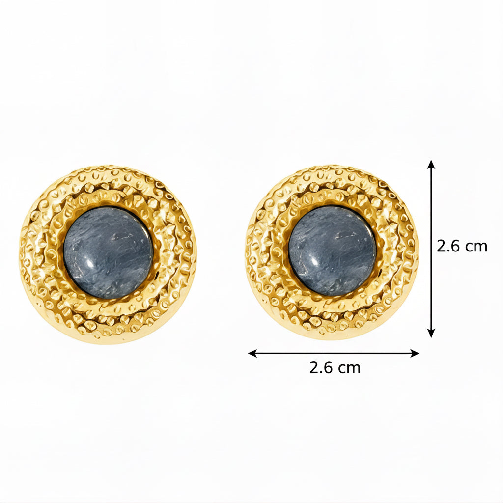 Pair of gold earrings with blue stones on a white background