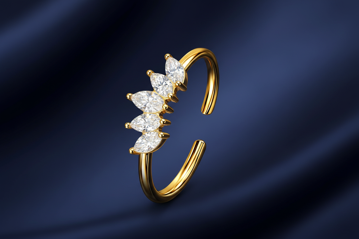 Gold ear cuff with diamond stones on a dark blue background