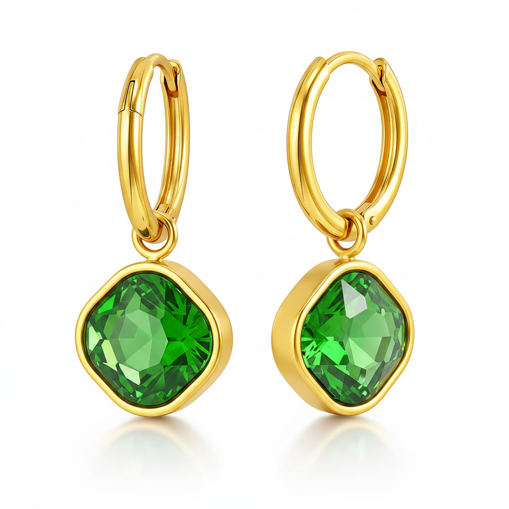 Gold hoop earrings with green gemstones on a white background