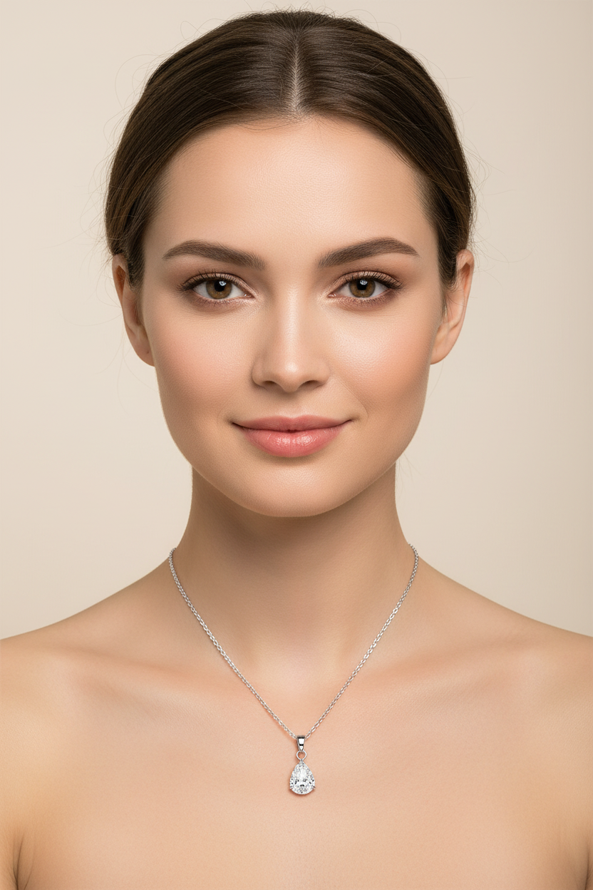 Woman wearing a water proof silver necklace with a pendant against a beige background