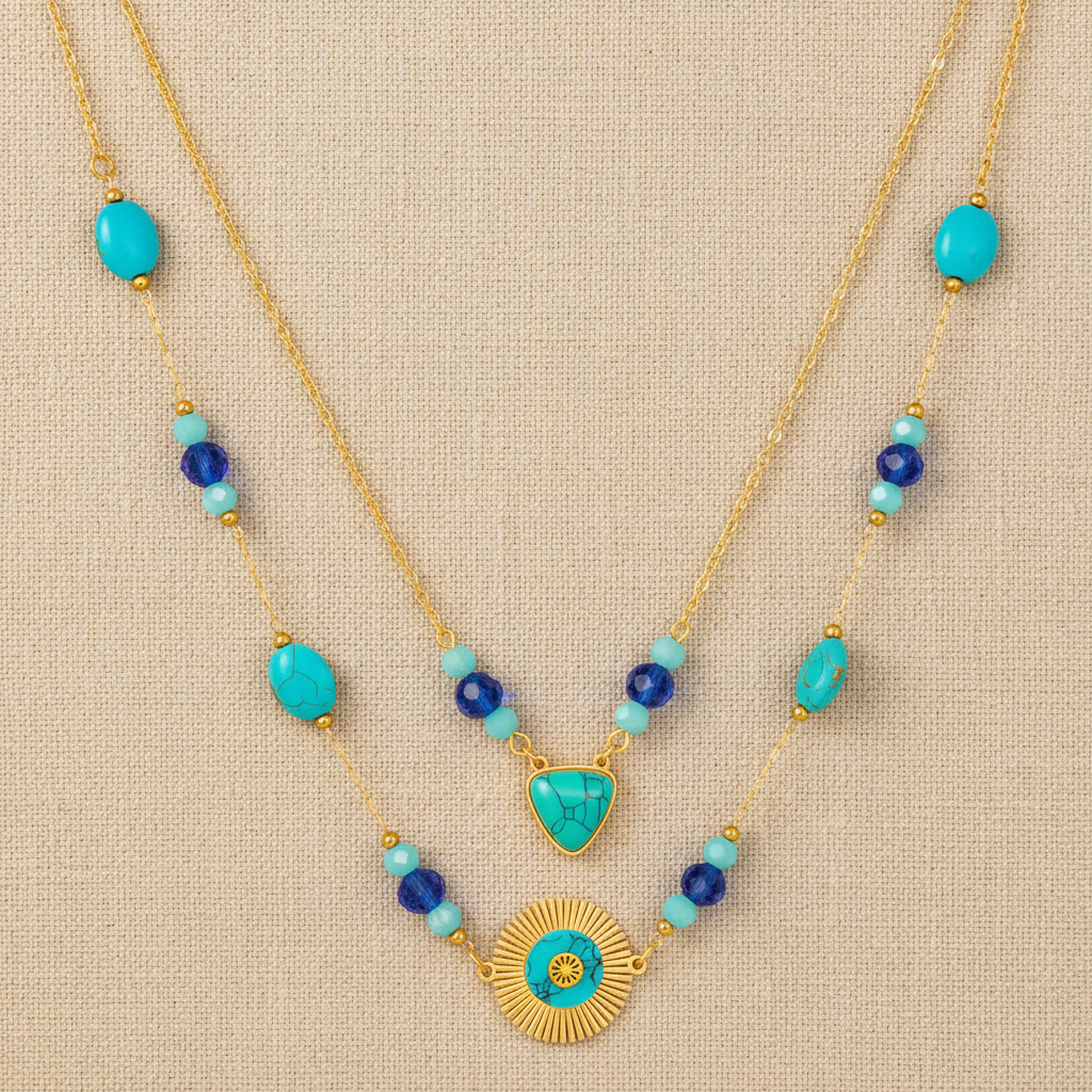 Necklace with turquoise and blue beads on a beige fabric background