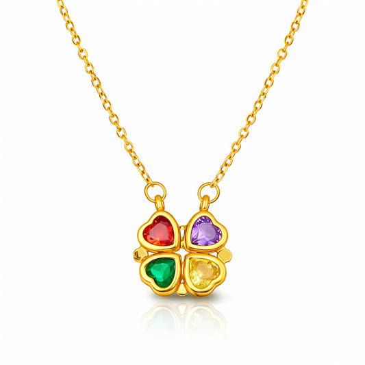 Gold necklace with a four-leaf clover heart shape pendant featuring colorful gemstones on a white background