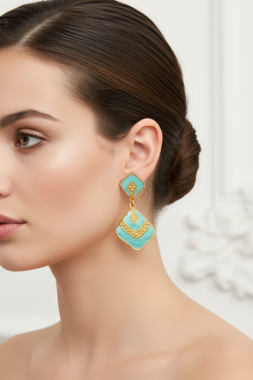 Turquoise and gold earrings on a white background