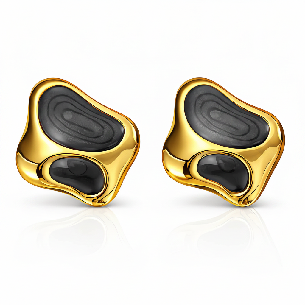 Gold earrings with black stones on a white background
