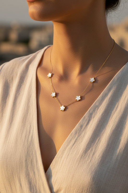Necklace with star-shaped pendants worn by a person in a soft light setting