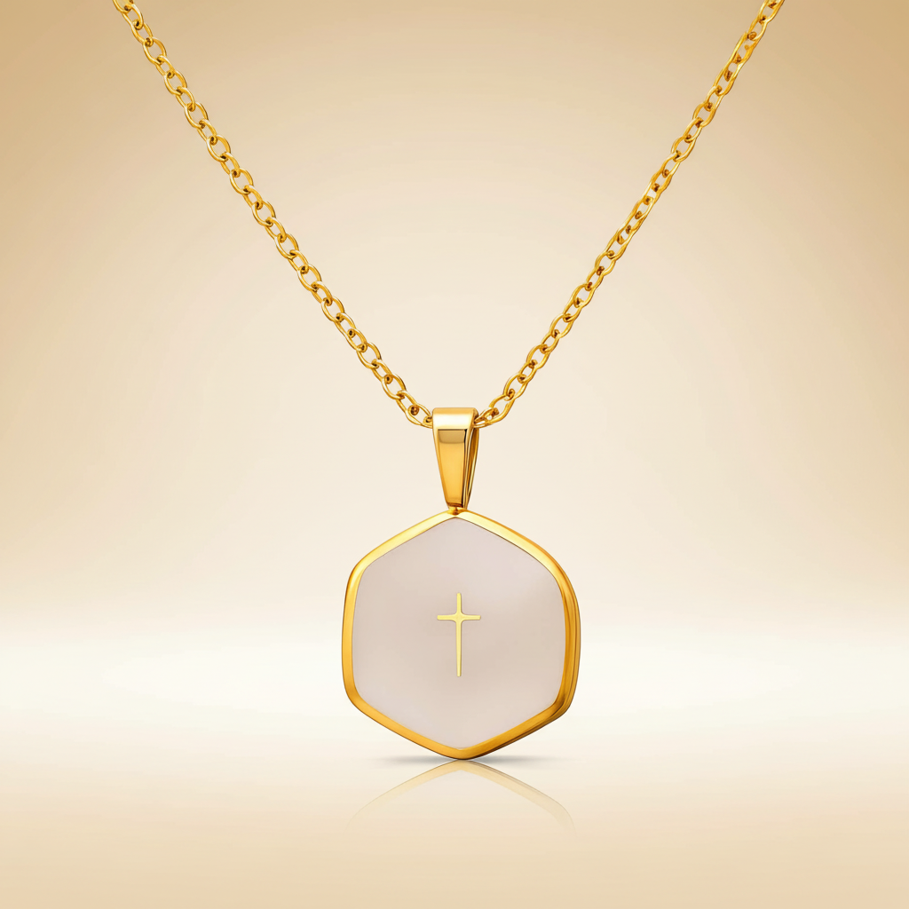 Gold necklace with a hexagonal pendant featuring a cross on a beige background
