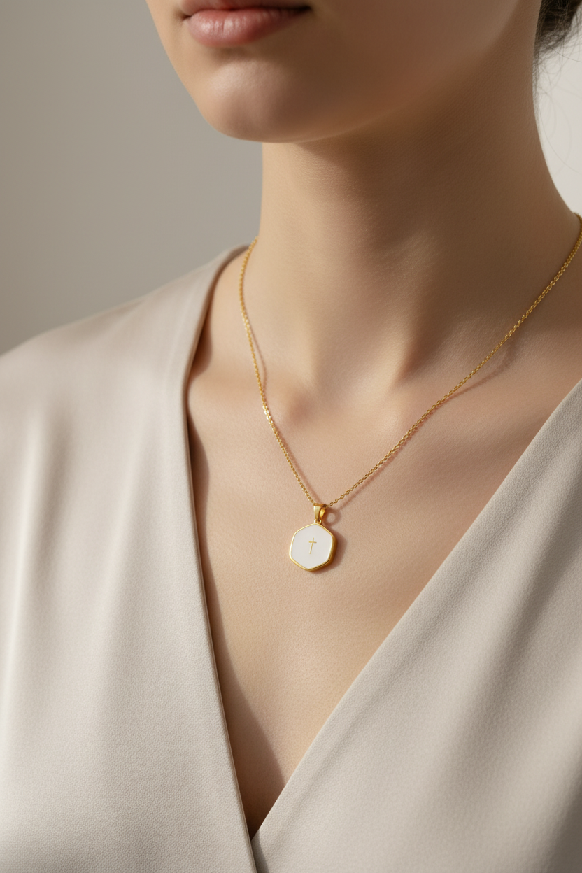 Necklace with a round pendant worn by a person in a neutral setting