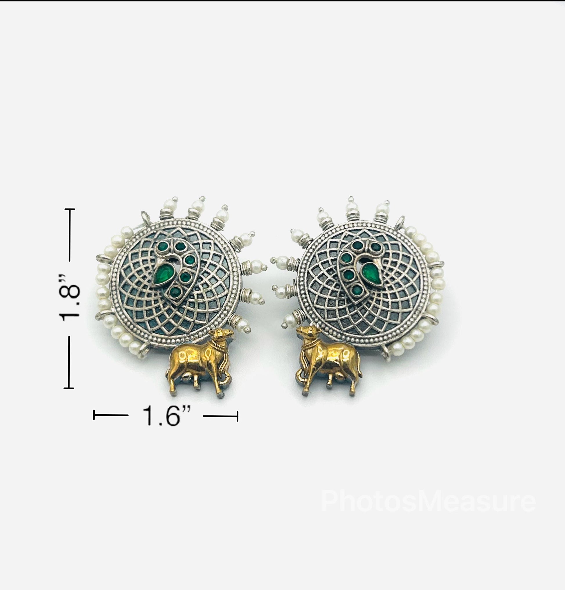 Pair of decorative earrings with measurements on a white background