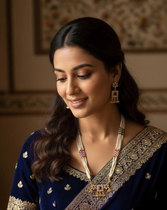 Woman wearing traditional jewelry and a saree with a blurred background