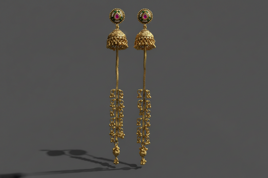 Gold earrings with intricate designs on a dark background