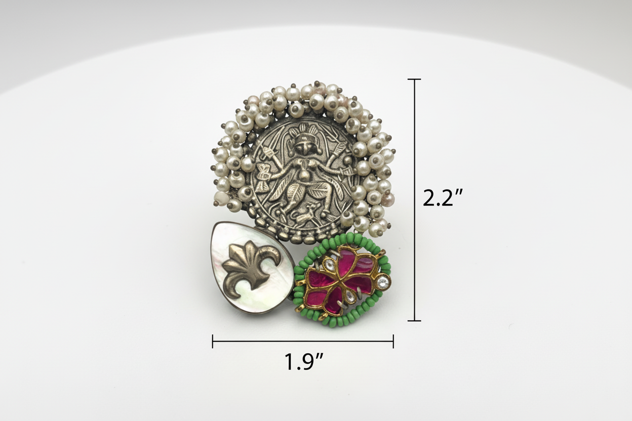 Decorative ring with pearl-like beads and gemstone details on a white background