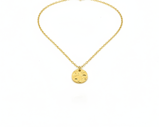 Gold necklace with a round pendant on a white background
