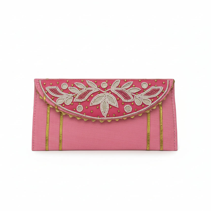 Pink clutch with white floral embroidery and gold accents on a white background
