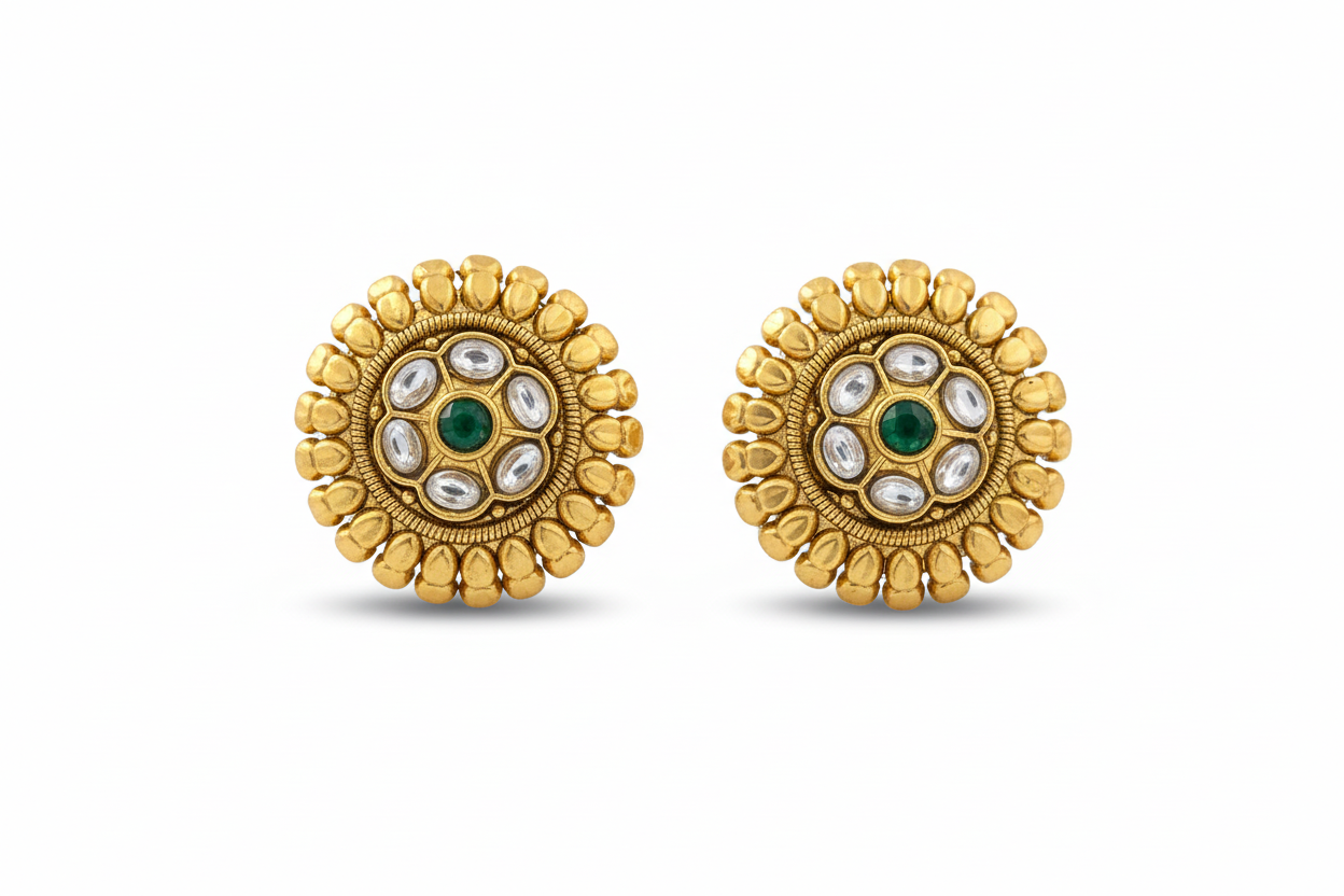 Pair of gold earrings with green and white stones on a white background
