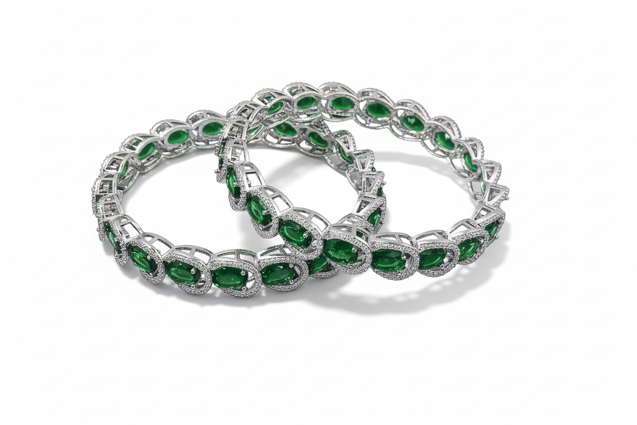 Two emerald bracelets on a white background