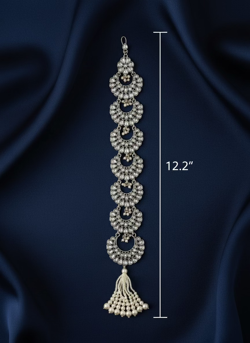 Decorative silver bracelet with tassel on a white background