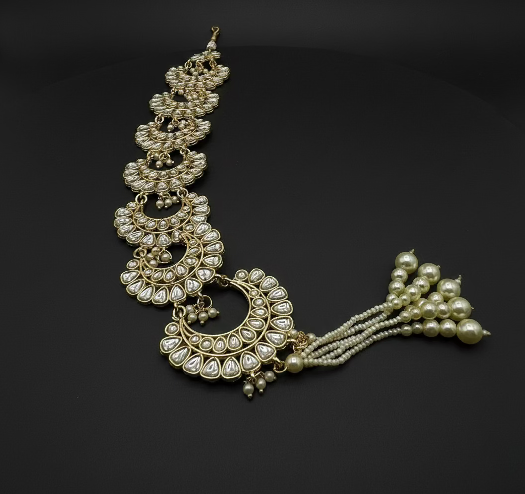 Gold and pearl necklace on a white background