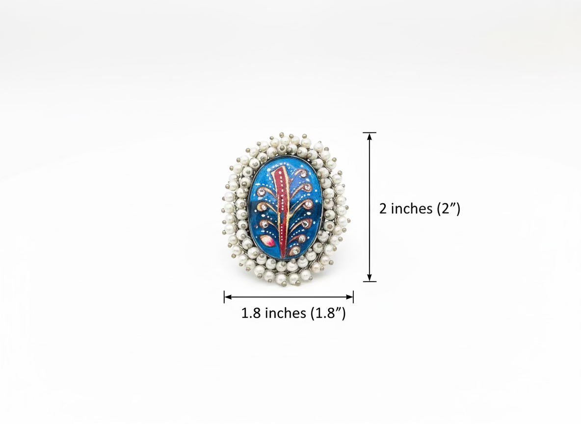 Decorative brooch with intricate design on a gray background