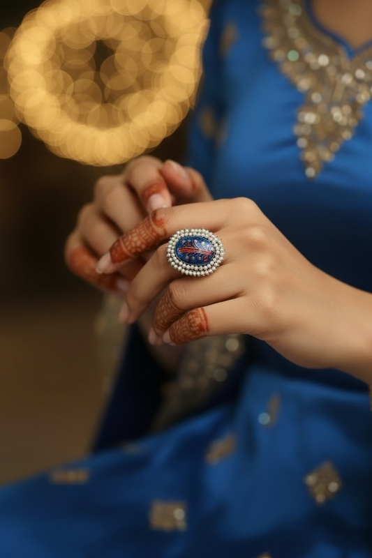 Decorative brooch with intricate design on a white background
