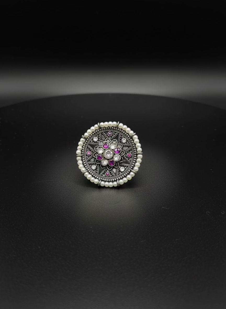 Decorative ring with gemstones on a white background