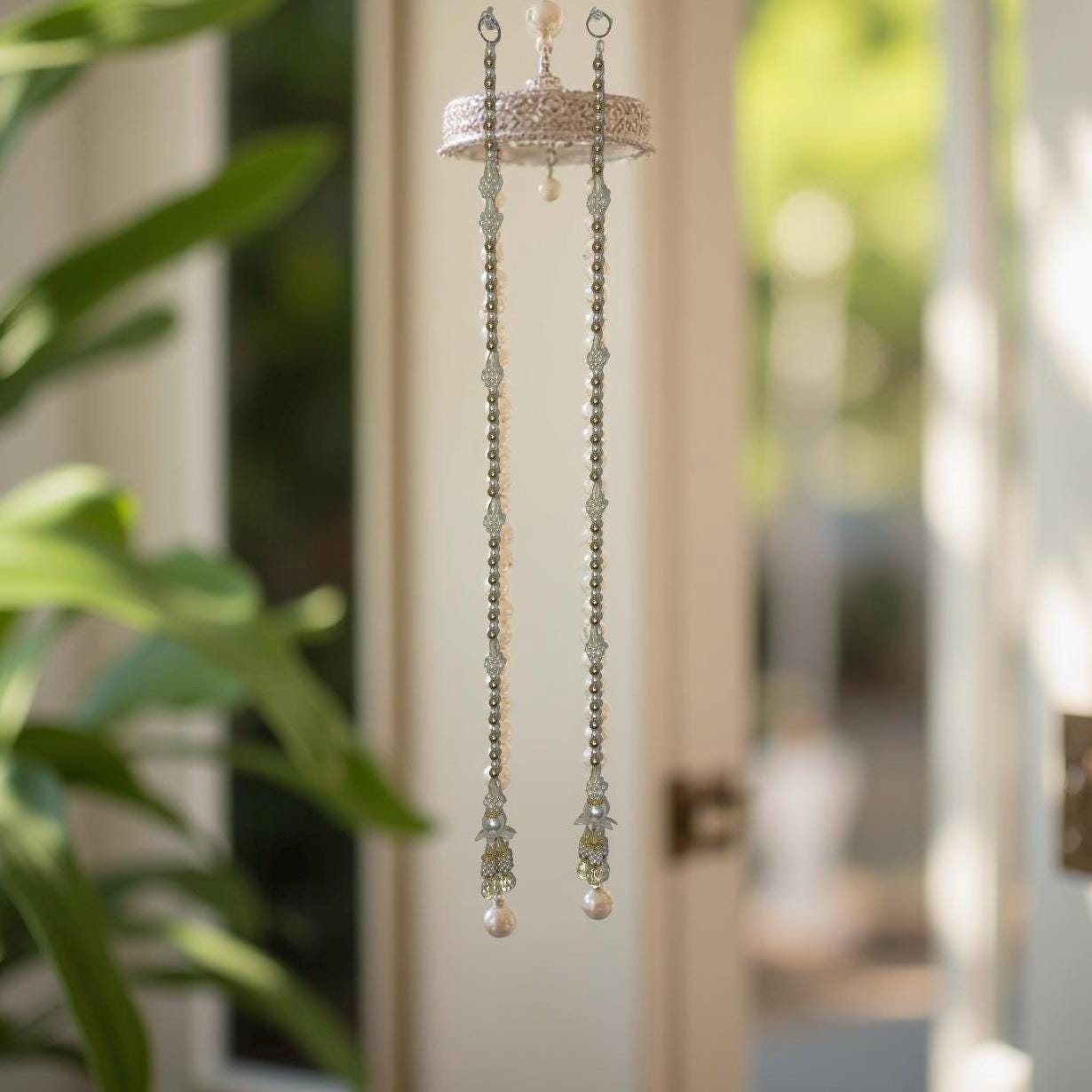 Decorative hanging chain with beads in a blurred indoor setting